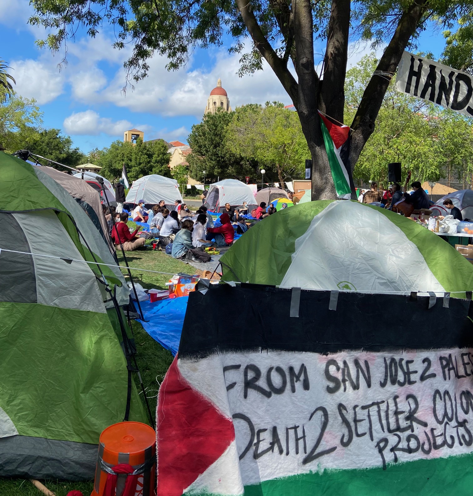 tents and banner "from San Jose: Stop Settler Colonization" 
